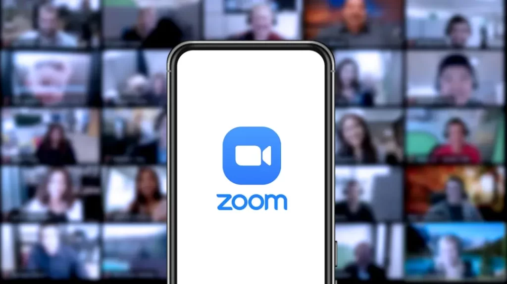 Zoom Logo On A Smartphone With A Video Call In The Background